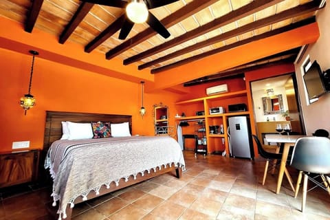 King Bed with super comfy pillowtop mattress, kitchenette and dining/work table for 4. Above are handmade terracotta tiles and wood beams.  AC, Smart TV, large en-suite bathroom.