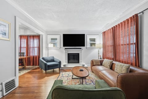Living Room: Relax in style with plush seating, a warm fireplace, and vibrant decor!