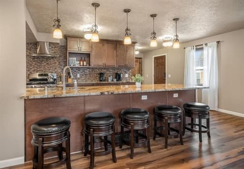 View Of Kitchen With 5 Bar Stool Seating