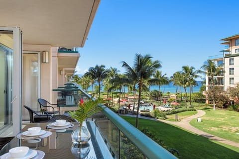 Tropical balcony bliss with ocean views and lush paradise below.