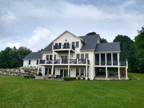 Back Yard Featuring Decks, Screened Porch, and Bluestone Patio Overlooking Lake