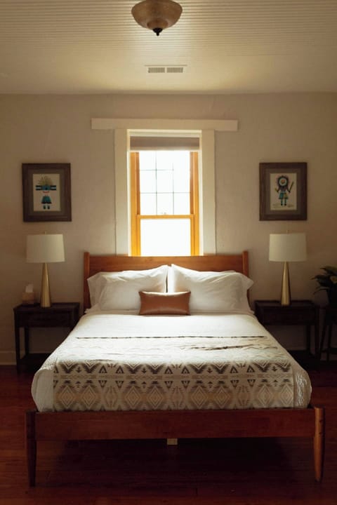 The main bedroom has a comfortable queen bed with hotel-style bedding.