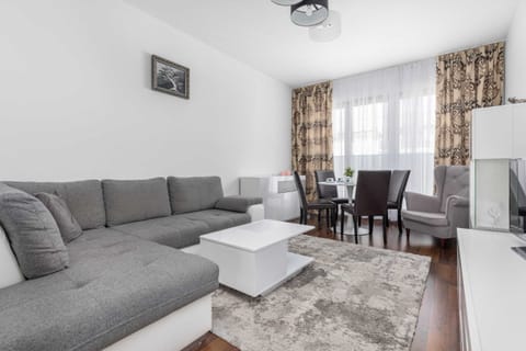 Spacious living room with a large sofa, coffee table, and a bright, modern design.
