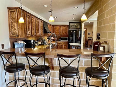 Additional seating for four at kitchen bar open to living area.