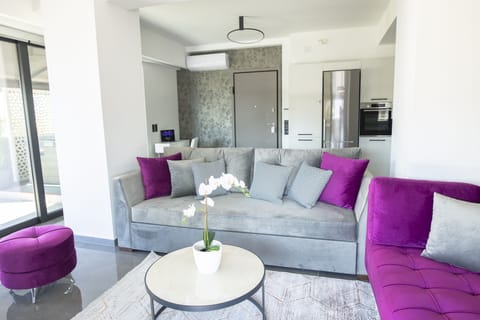 Premium quality sofas and floor to ceiling windows throughout the living room.