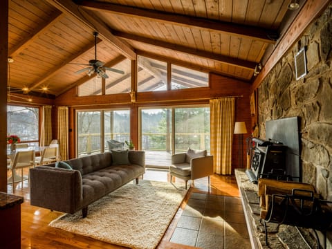 Main Cabin- dining, kitchen, fireplace, common area, walk in/out to patio