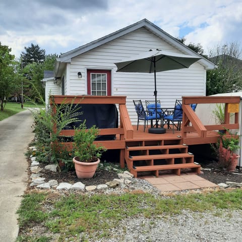 Deck with table seating for 4 and gas grill.