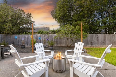 Relax on the extra large back patio with a Solo Stove fire pit and string lights
