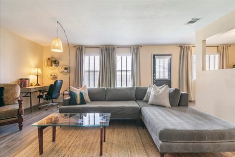 Large living room with natural light from backyard. Decorative fireplace.