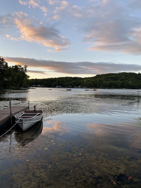 Dock, boat, and lakefront at sunset
