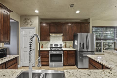 updated kitchen with stainless steel appliances and granite countertop