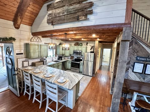 Gather around the kitchen table that seats six, the island for three, or the bar table for a couple more.