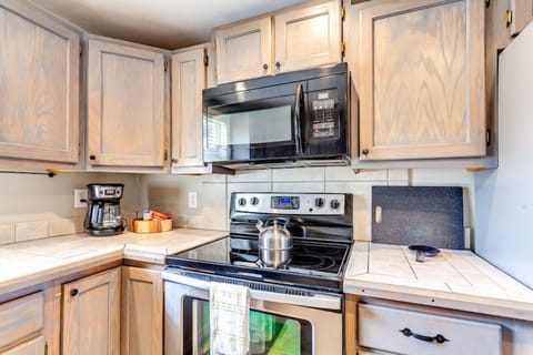 The kitchen features a stove, an oven, a microwave, and more!