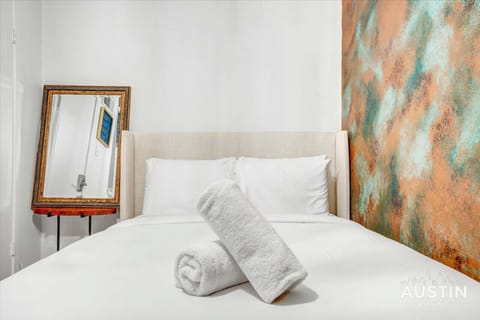 Queen bed up the spiral staircase with luxury custom hotel quality linens