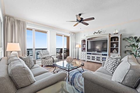 Oceanfront living room with balcony access.