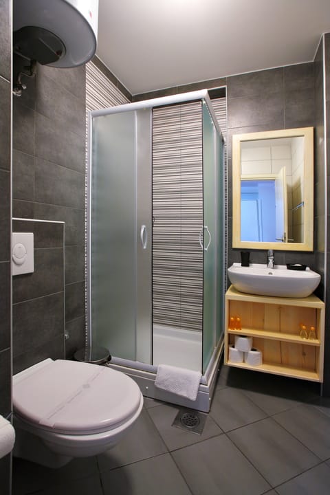 Shower, designer toiletries, hair dryer, slippers