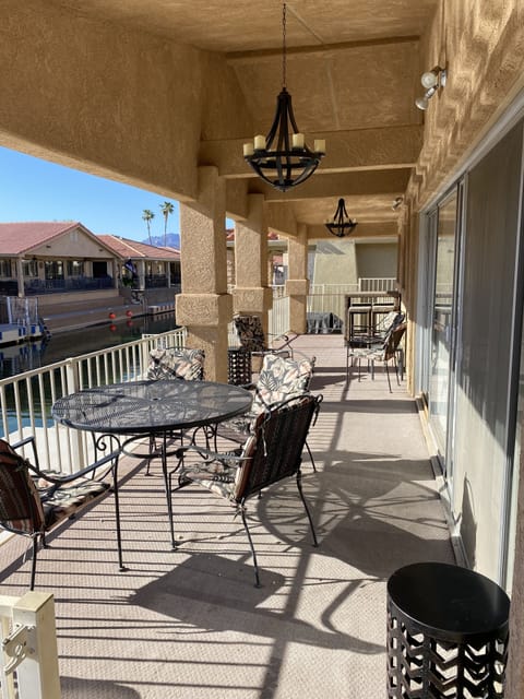 Gated covered patio w/  seating , tall bar and overhead lighting.