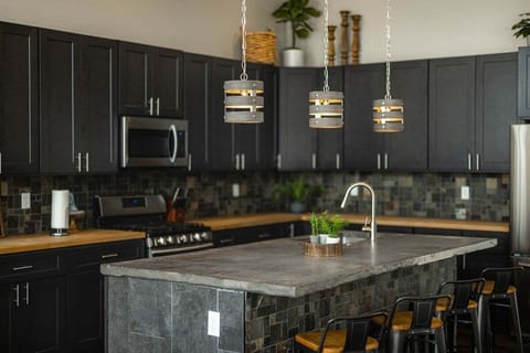 This rustic kitchen combines traditional charm with modern convenience, featuring ample counter space and all necessary cooking tools. Enjoy the cozy atmosphere as you prepare meals in this inviting culinary haven.