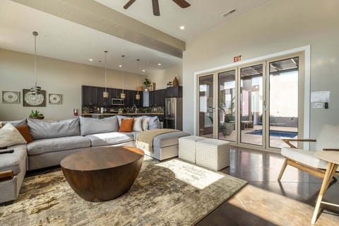 Relax in this spacious living room, complete with a plush sectional that offers plenty of seating. The flat-screen TV is ideal for entertainment, while the foosball table adds a touch of excitement and a playful ambiance.