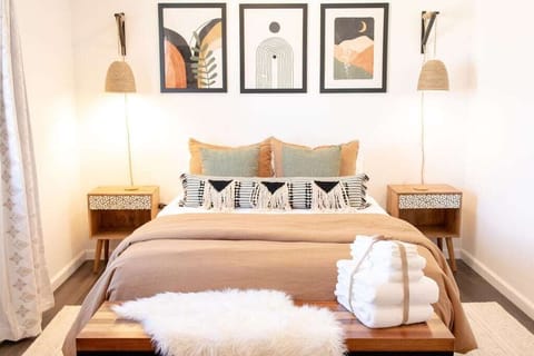 Primary bedroom with queen bed, blackout curtains, USB outlets, reading nook.