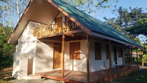 Backside of the house with outdoor shower on bottom left. Private balcony up top