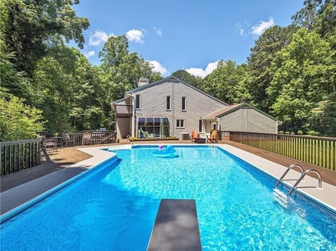 Enjoy a large fenced-in heated pool with a diving board and plenty of outdoor seating!