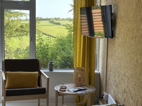 Living area with picture windows and views towards Exmoor