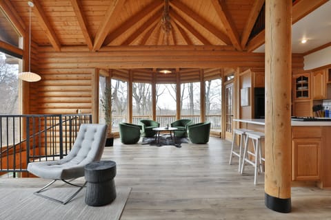 First Floor living area. Couches, chairs, a full kitchen, walkout deck and views