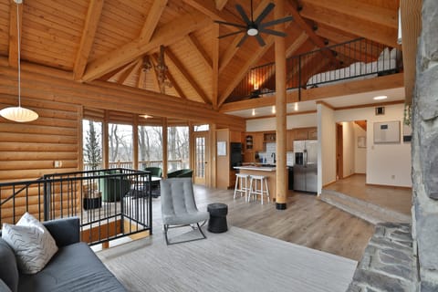 First Floor living area. Couches, chairs, a full kitchen, walkout deck and views