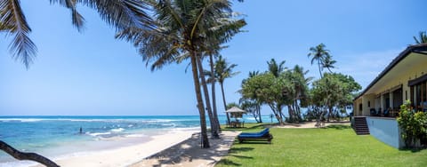 Garden leads to a soft sandy beach - sea good for swimming and snorkelling.
