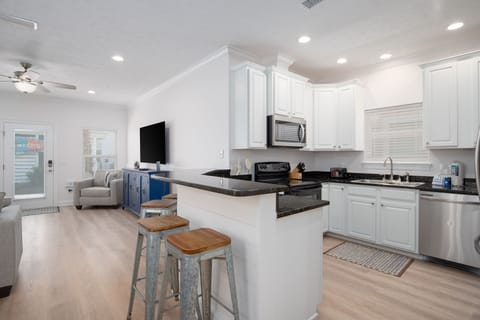 Fully equipped kitchen with granite counters and new French door fridge. 