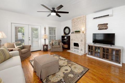 Large living area with door leading to side porch