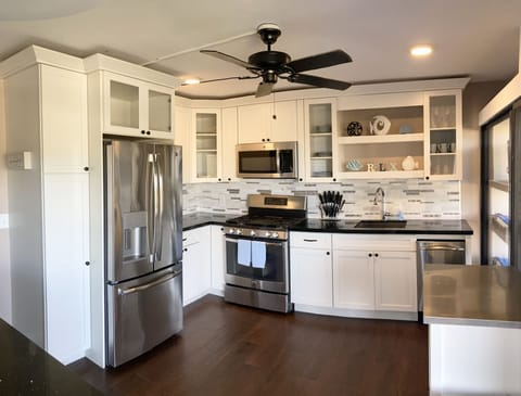 Fully furnished kitchen with cookware, dishes, etc. Eat out or stay in.
