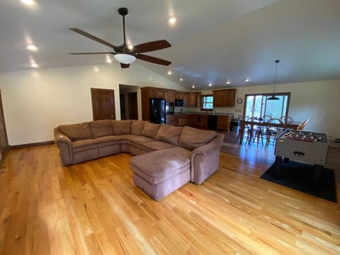 Living room view with the kitchen and dining room.  Dining table seats 6.