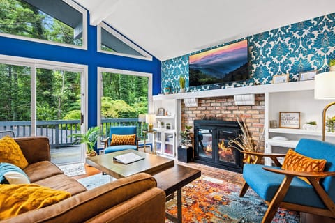 Cozy living room with LED Smart TV, Bluetooth speaker, and lush furniture.