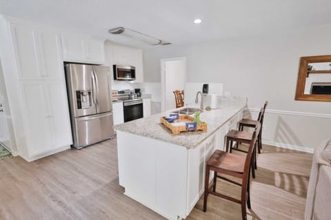 Full kitchen view with bar seating!