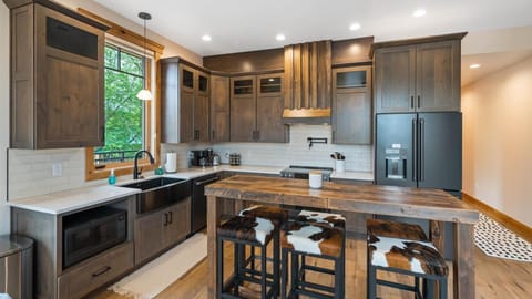 Fully stocked kitchen with top of the line appliances, breakfast bar seating for 6, and convection stove top.