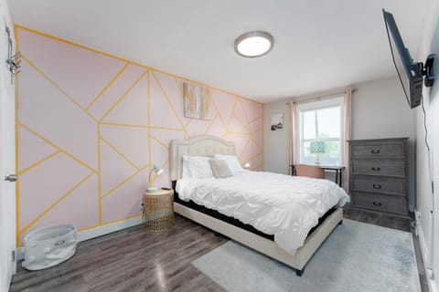Step into a sanctuary of refined modern living. Immerse yourself in opulence with a cutting-edge TV, a luxurious full-length mirror, and minimalist elegance. Enjoy curated artwork set against soothing pastel tones, complemented by rustic accents that add a touch of warmth to this exquisite space.
