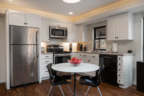 Your fully equipped kitchen features granite counters, stainless appliances, and a cozy dining nook where you can savor morning coffee or plan your adventures.