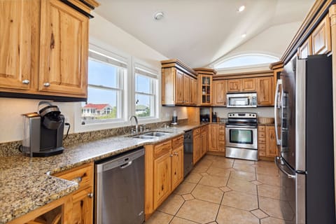 Whip up a delicious meal in the Modern Kitchen with stainless steel appliances, 2 Refrigerators, 2 Dishwashers, 2 Microwave Ovens, a Range, and a Wine Cooler.