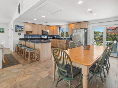 Enjoy open-concept dining with the well-stocked Kitchen and two dining tables.