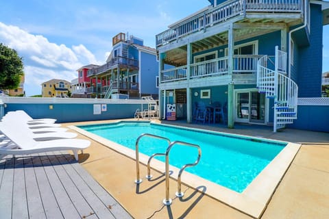 The large 14' x 27' private pool is surrounded by lounge seating, creating the perfect spot for sun-soaked afternoons.