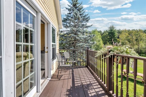 private balcony with views of backyard, forest, and mountains