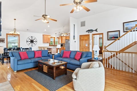 Living Area: Gather with family in the spacious living room with vaulted ceilings, cozy fireplace, and large smart TV.