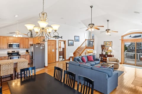 Living Area: Gather with family in the spacious living room with vaulted ceilings, cozy fireplace, and large smart TV.