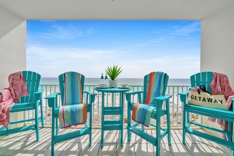 Picture yourself sipping morning coffee on your private balcony, surrounded by vibrant turquoise chairs and gulf breezes.