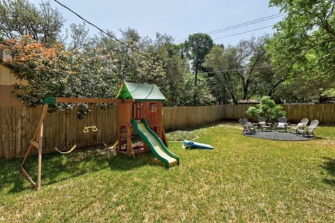 Private fenced yard with playscape—perfect for families in Austin.
