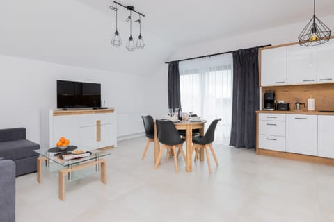 A fully set dining table with plates, cutlery, glasses, and napkins, creating a welcoming atmosphere.