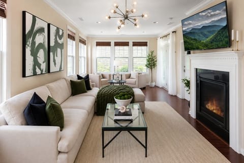 Experience the epitome of modern living with our sun-soaked, stylish living room adorned with a plus couch, a sprawling HD TV for your entertainment, & a charming fireplace that adds a touch of warmth and coziness.   Book your retreat today!