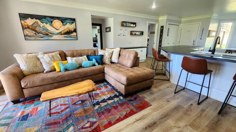 Cozy, stylish living space with vibrant décor, comfy seating, and open kitchen perfect for gathering together